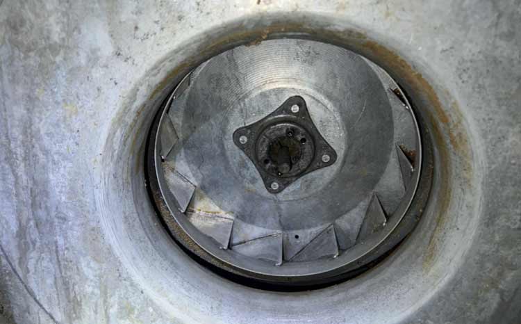 Close-up of a thoroughly cleaned commercial exhaust fan impeller blade free of grease and debris.