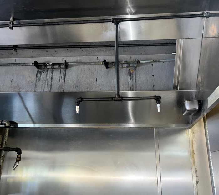 Fully degreased hood interior and piping system showing the after results of a comprehensive San Diego kitchen exhaust cleaning.
