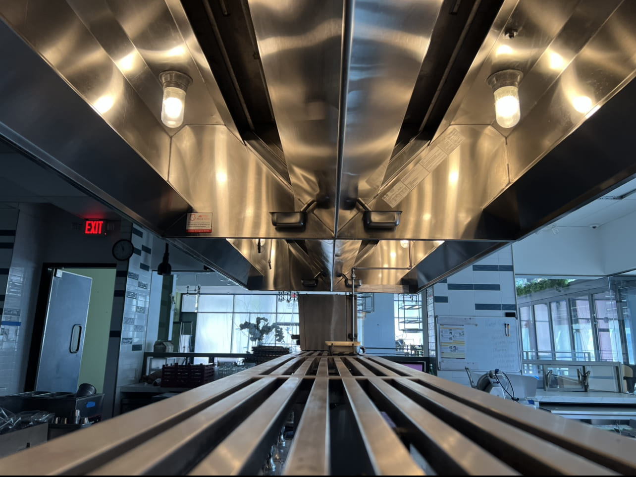 Deep  Kitchen Hood Cleaning in Escondido, CA with bright lighting and polished surfaces in a professional San Diego restaurant.