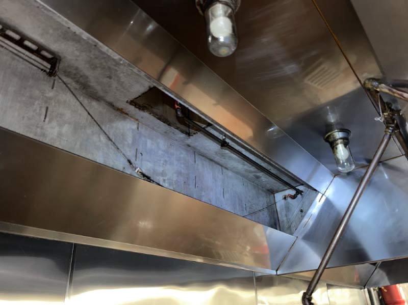Stainless steel hood plenum with filters removed after kitchen hood cleaning in Downtown San Diego