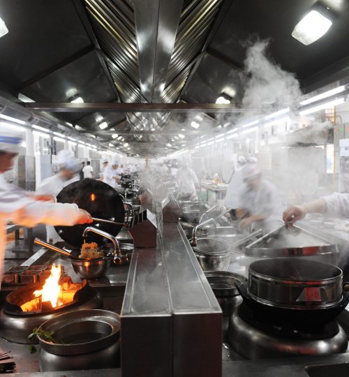 Motion chefs in a Chinese restaurant kitchen.